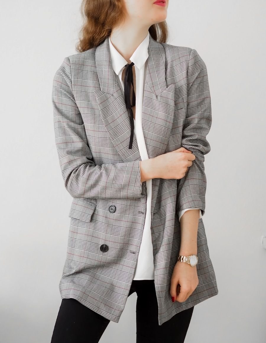 Tailored soft-shouldered jacket in a pale check worn open over a white silk shirt