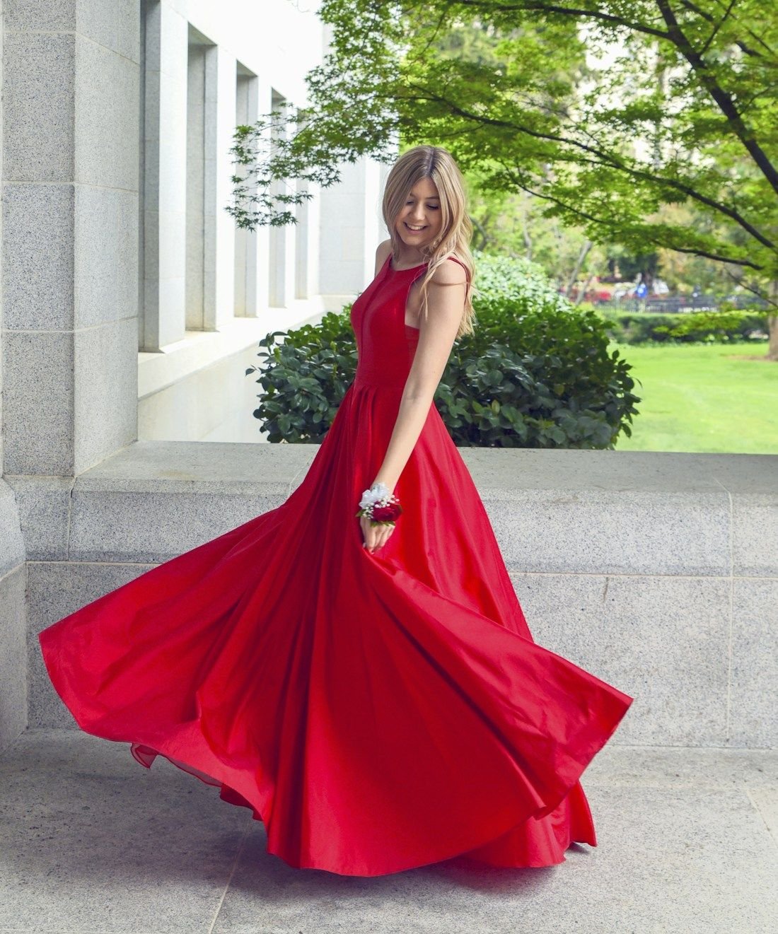 Full-length silk gown with a wide sweeping skirt turning under a colonnade